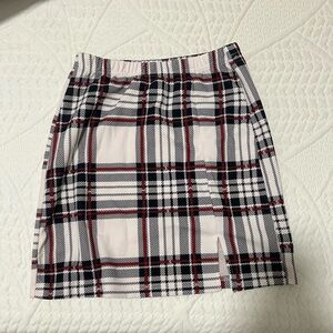 White skirt with black and red plaid stripes